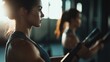 ©  Shomixer - Two women are engaged in a workout at the gym, using fitness equipment with determination and focus, exemplifying strength, dedication, and the pursuit of fitness goals.