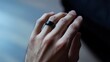 © Felippe Lopes - Close-up of a male hand wearing a sleek black smart ring.