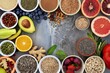 © Olsek - Various healthy superfoods displayed beautifully on a concrete background. Fresh fruits, nuts, seeds, and grains arranged in a circular pattern. Perfect for health, diet, and wellness themes