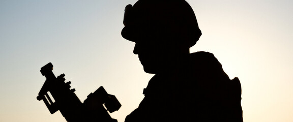 Silhouette of a soldier holding a rifle