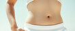 © Rysak - Closeup of woman's toned stomach and belly button
