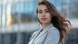 © Naru - A portrait of a confident young woman in a professional suit, standing in front of a modern cityscape. The image conveys ambition, success, and empowerment.