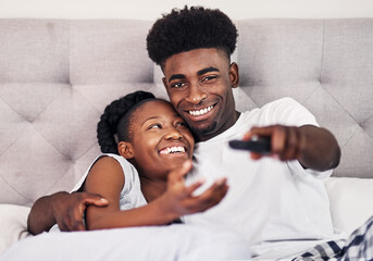 Canvas Print - Black couple, people and happy with watching tv in bedroom with subscription for series or movies. Relationship, love and smile with remote on bed for bonding, support and entertainment at home