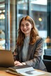 © vefimov - Young female business professional using a laptop