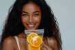 © StockLab - A woman in her 20s, holding an IV vitamin bag with orange slices, showcasing rejuvenation and revitalization benefits from an IV vitamin drip