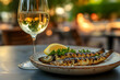 © alfi - Crisp glass of Vinho Verde paired with grilled sardines on a rustic plate, outdoor seaside setting at sunset