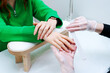 © Екатерина Переславце - A woman is getting her nails done by a manicurist