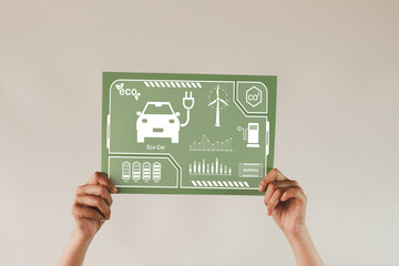 Eco car,Wind Energy,Clean Energt,Green technology,Eco friendly,Renewable Energy concept.,Woman hand holding green paper with electric car icon idea for sustainable.