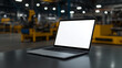 © Iana - Laptop mockup with a white screen on a metal workbench with industrial tools and machinery in the background