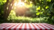 © Kanan - Spring backgrounds: empty table covered with red and white picnic tablecloth and defocused lush foliage at background. Ideal for product display on top of the table
