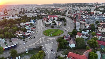 Wall Mural - Drone captures traffic at Podul de Piatra roundabout during sunset