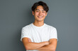 © wazamai - smiling asian man in white t-shirt with arms crossed against gray background