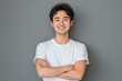 © wazamai - smiling asian man in white t-shirt with arms crossed against gray background