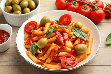 Sticker - Delicious pasta with tomato sauce, basil and olives in bowl on wooden table, closeup