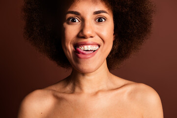 Wall Mural - Cropped photo of positive tricky lady naked shoulders smiling licking lips isolated brown color background