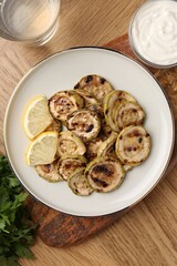 Poster - Tasty grilled courgette slices served on wooden table, flat lay