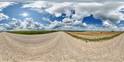 Wall Mural - spherical 360 hdri panorama on side of gravel road with rain storm clouds in dark sky in equirectang