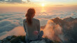 © NooPaew - Young woman gazing at a pastel sunrise from a mountain top, surrounded by low-lying clouds, rear view