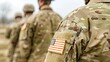 © pvl0707 - Close-up of US soldiers' uniforms showcasing American flag patches during a military gathering