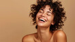 © NooPaew - Portrait of a carefree laughing woman enjoying a spa treatment, bare shoulders, on a beige background