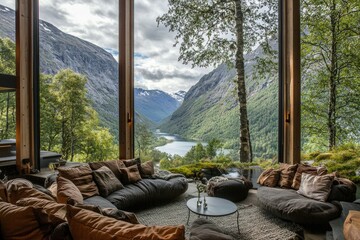 Cozy interior with plush seating, offering stunning views of mountains and a serene river in the background.