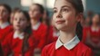 © vefimov - Portrait of young girl wearing a red school uniform, smiling and looking ahead with hopeful eyes.