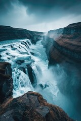 Wall Mural - The image captures a dramatic waterfall in Iceland, showcasing the power of nature and the appeal of the country's natural landmarks.