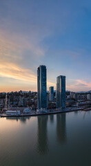 Wall Mural - Modern City by river at sunset twilight. New Westminster, Vancouver, BC, Canada.