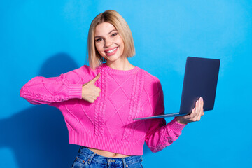 Poster - Portrait of nice young woman thumb up laptop wear pink sweater isolated on blue color background