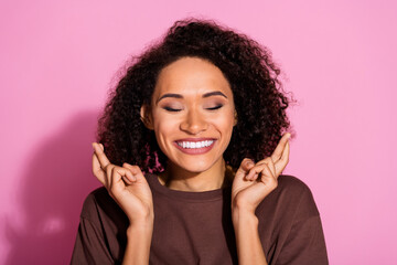 Sticker - Photo of nice young girl crossed fingers wear brown t-shirt isolated on pink color background