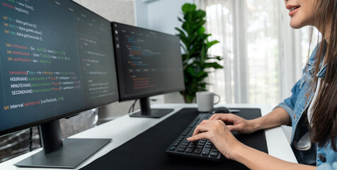 Wall Mural - young asian in it developer creating with typing online information on pc with coding program data o