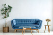 © Iryna - Modern living room with empty white wall, blue sofa, plants and coffee table. Modern interior for wall art mockup. Promotion background with copy space.