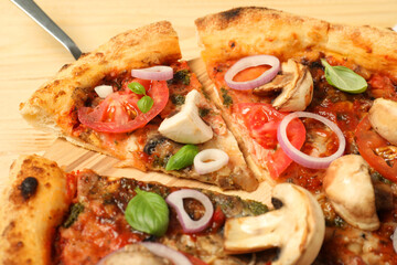 Canvas Print - Tasty pizza with basil, mushrooms, onion and tomato on wooden table, closeup