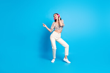 Poster - Full body portrait of nice young lady dancing headphones wear top isolated on blue color background