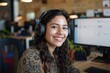 © CojanAI - Portrait of a smiling young Hispanic female IT support worker in startup company office