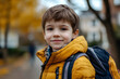 © john - Cute boy walking or going to school in fall day