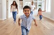 © spyrakot - Excited Family Exploring New Home - Parents and Children Running Through Spacious Modern House