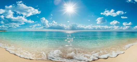 A photo of a clear blue sky and turquoise sea with white clouds on the horizon, a sandy beach in front of it