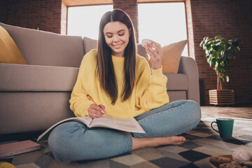 Canvas Print - Full size photo of attractive teen woman sit floor do homework eat snacks dressed yellow outfit cozy day light home interior living room