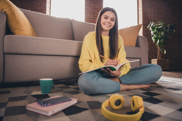 Sticker - Full body photo of nice teen girl sit floor do homework write textbook wear yellow clothes modern interior flat indoors