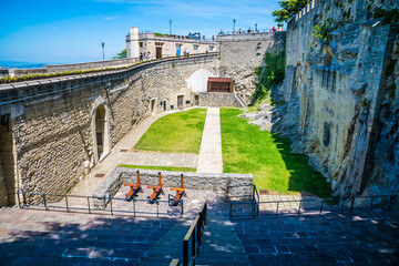 Wall Mural - A view above the crossbow mans cave in the fortified section of San Marino, Italy in summertime