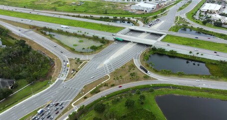 Wall Mural - Aerial view of diverging diamond interchange transportation infrastructure in USA city. Wide multilane highway crossroads with fast driving cars in Sarasota, Florida.