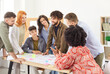 © Studio Romantic - Diverse group of young business people company employees in casual clothes discussing job projects talking in office making great decisions with brainstorming. Coworkers working together at workplace