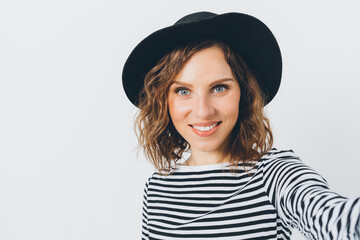 A woman with a black hat and a white