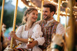 © Dzmitry - Joyful moments on a carousel with friends enjoying the playful atmosphere and vibrant colors at a local fair