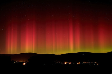 Wall Mural - an image depicting the aurora borealis as a celestial paintbrush, streaking the night sky with vibra