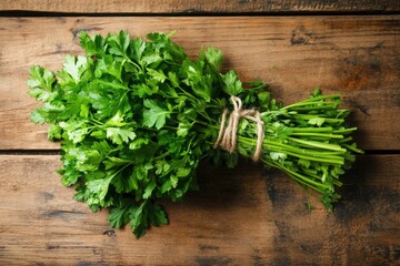 Bunch of fresh parsley tied with twine on rustic wooden table