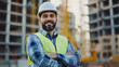 © VisionalMedia - Portrait of a smiling male engineer standing with arms crossed on construction site