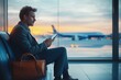 © kenkuza - Airport Terminal: Businessman using smartphone waiting for flight