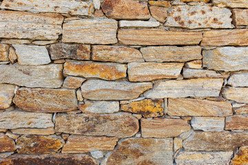 Close-up of a Rustic Stone Wall with Weathered Textures and Natural Earth Tones